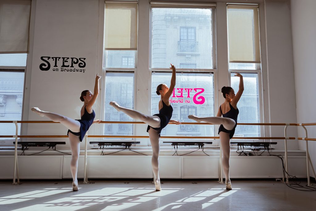 Steps Pre Professional dancers at the barre as light pours in through the windows