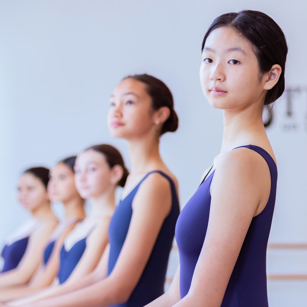 row of Steps on Broadway Academy dance students at the barre