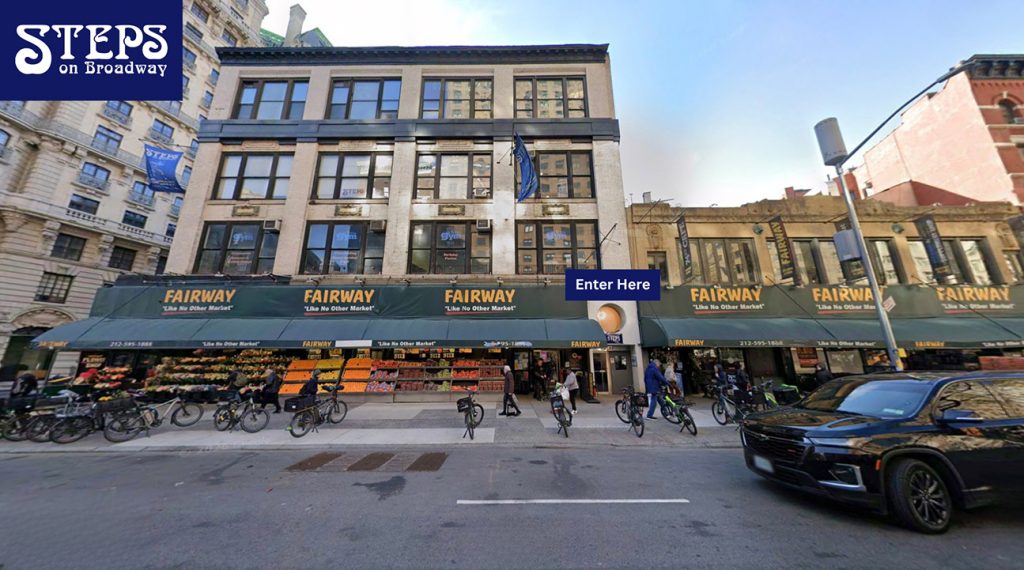A view of Steps Studios from across the street, with Fairway on the first floor and a label that says "Enter Here" above Steps' door.