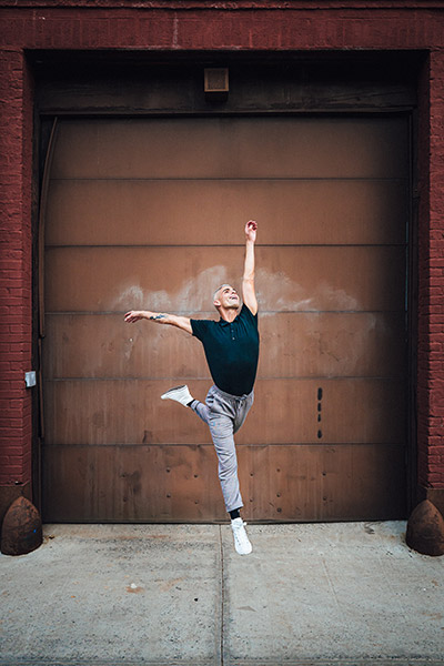 Bryan Knowlton dancing, leaping in front of garage door