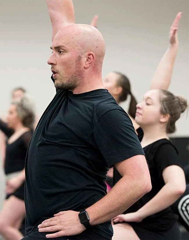 Todd Shanks in a black t-shirt teaching a dance class