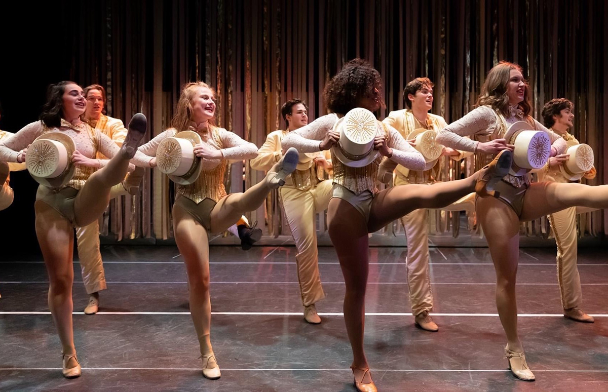 Roosevelt University's Chicago College of Performing Arts Dance student pefroming on stage in a kick line