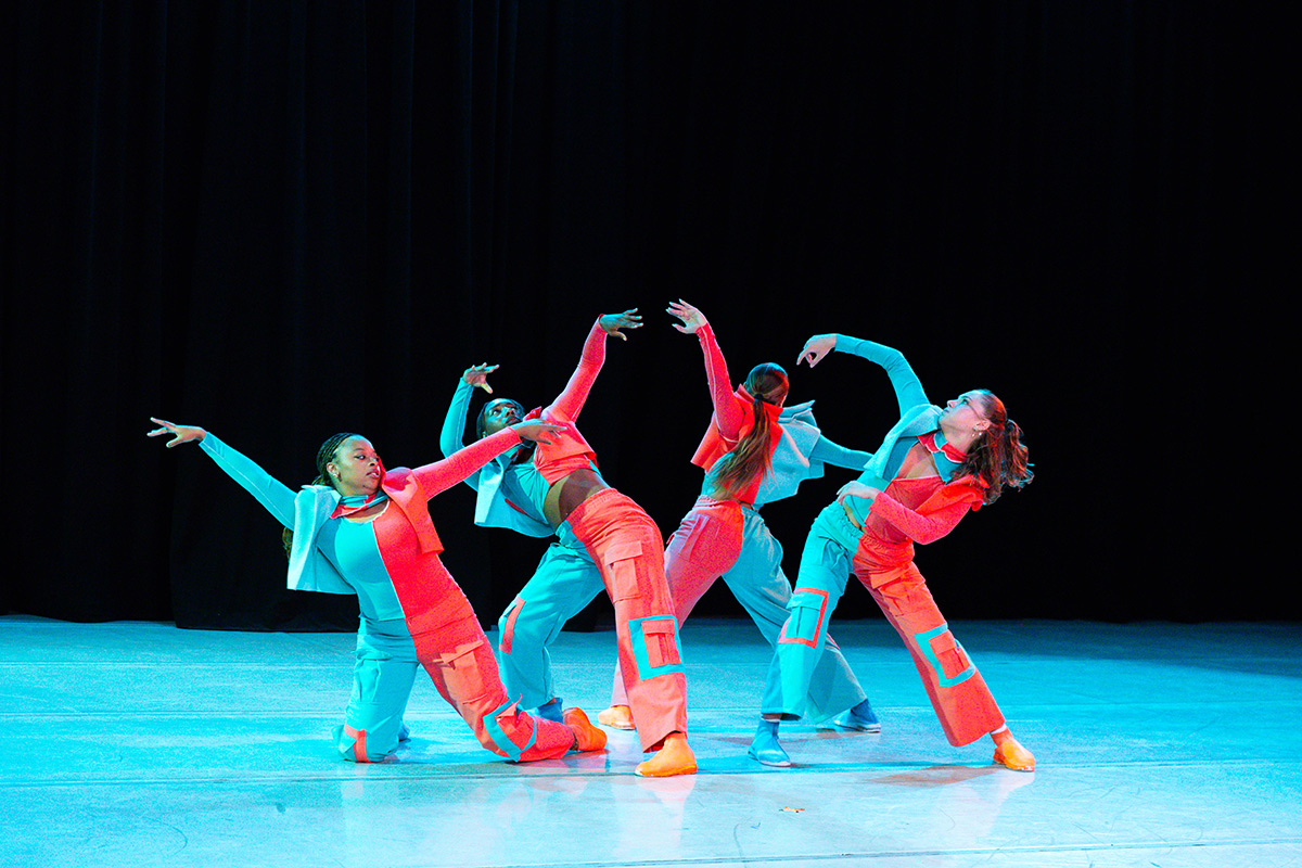 LMU Dance students performing on stage in cyan and bright blue